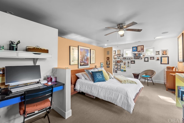 carpeted bedroom with ceiling fan and baseboards