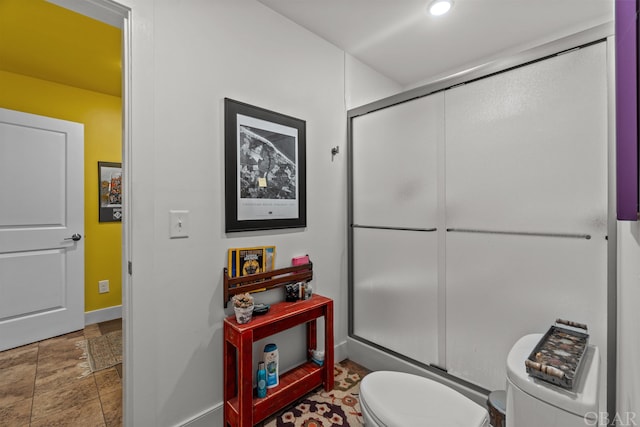 full bathroom with baseboards, toilet, stone finish flooring, an enclosed shower, and recessed lighting