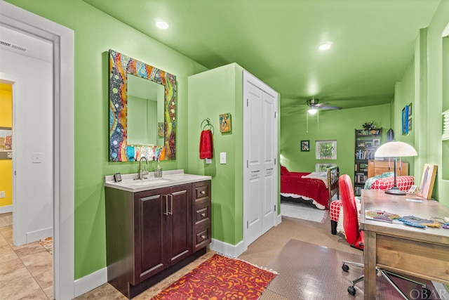 ensuite bathroom with visible vents, a ceiling fan, connected bathroom, vanity, and baseboards