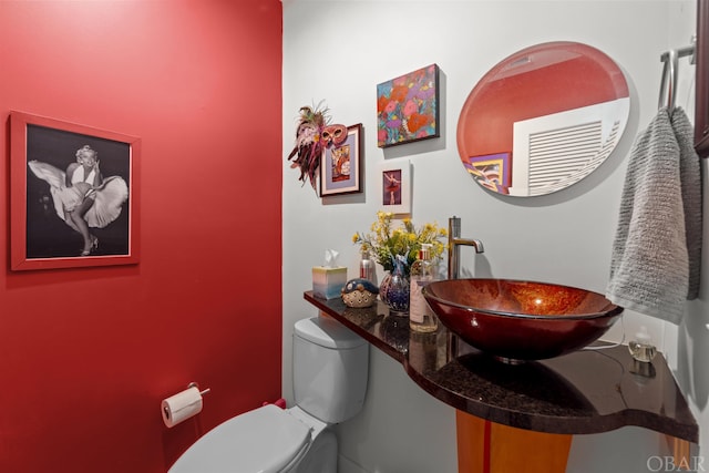 bathroom with toilet and a sink