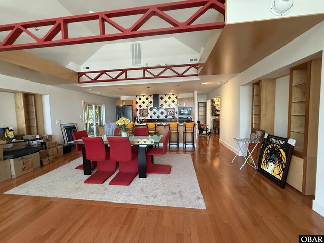 106 Prince Charles Ct Lot 45, Kill Devil Hills, NC 27948 - dining area featuring wood finished floors, high vaulted ceiling, and baseboards