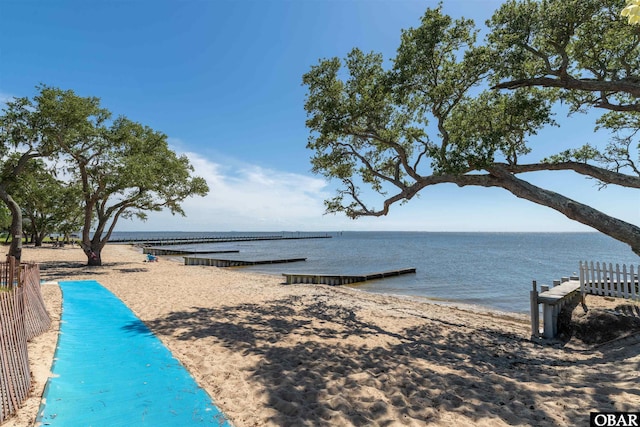 water view with a view of the beach and fence