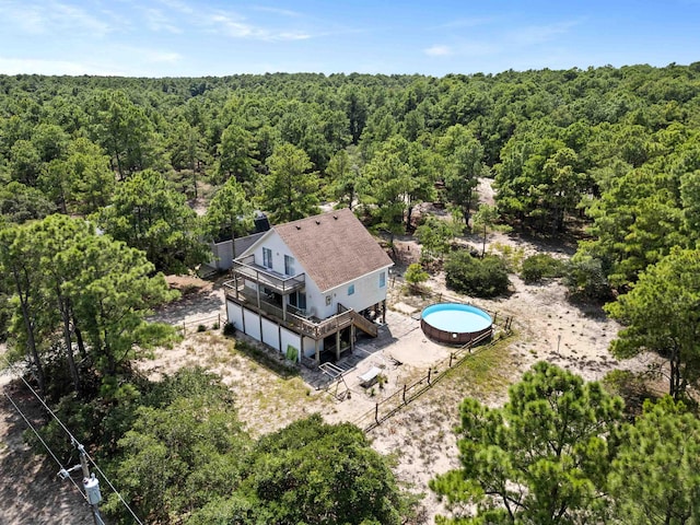 birds eye view of property featuring a view of trees