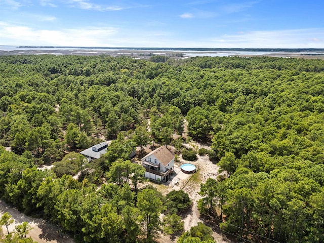 drone / aerial view featuring a water view and a forest view