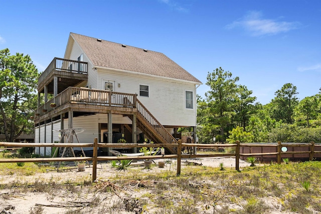 back of property with a shingled roof