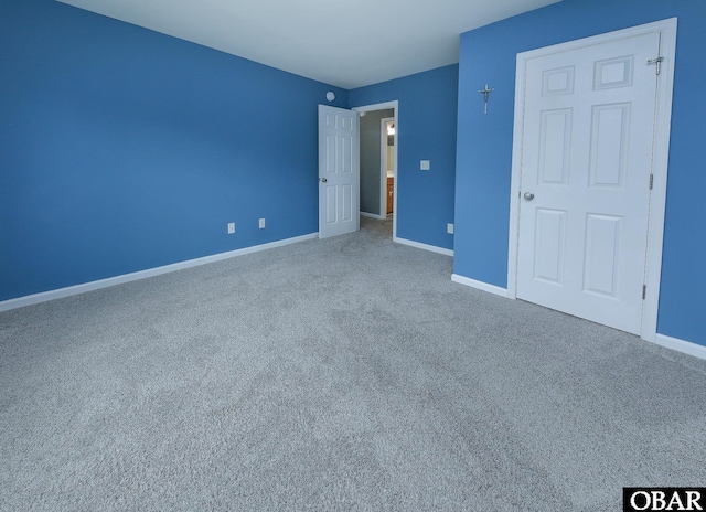 unfurnished bedroom with baseboards and carpet