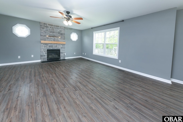 unfurnished living room featuring baseboards, a ceiling fan, and dark wood-style floors