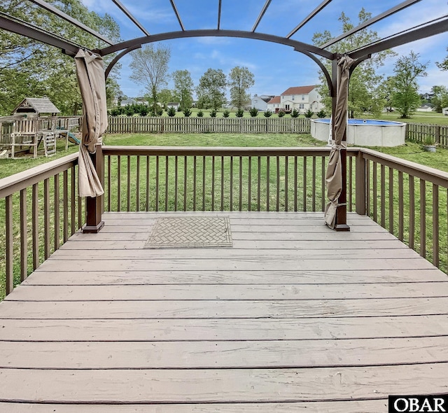 wooden deck with a fenced backyard and a yard