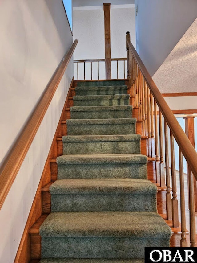 stairway with wood finished floors