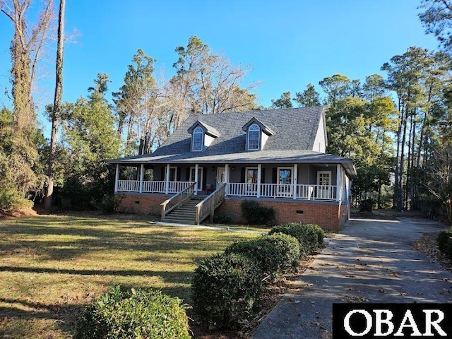 view of front of property with covered porch, stairway, crawl space, and a front yard