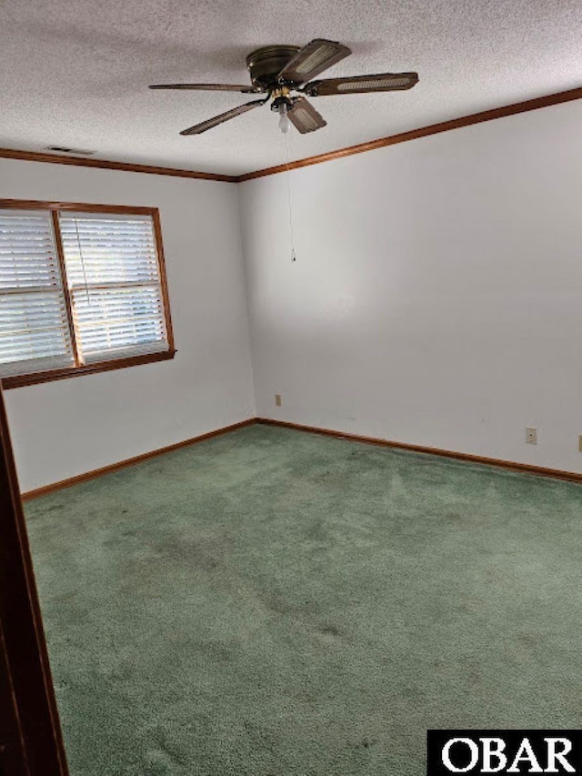 carpeted empty room featuring visible vents, crown molding, a textured ceiling, and ceiling fan