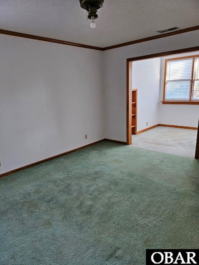 7013 Currituck Rd Lot 4, Kitty Hawk, NC 27949 - empty room with ornamental molding, a textured ceiling, and carpet floors