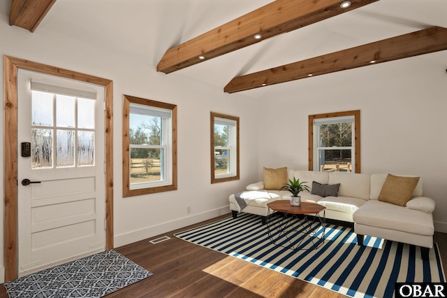 living room with visible vents, baseboards, wood finished floors, and vaulted ceiling with beams