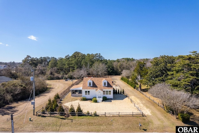 birds eye view of property featuring a view of trees and a rural view