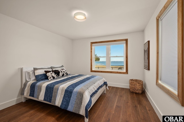 bedroom featuring baseboards and wood finished floors