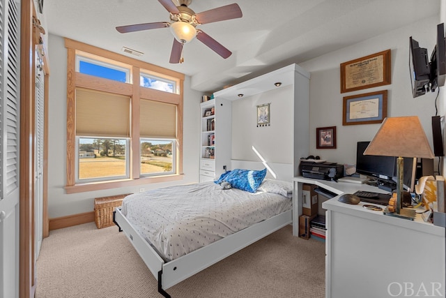 bedroom featuring light carpet, multiple windows, and visible vents