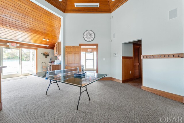 playroom featuring wood ceiling, light carpet, plenty of natural light, and baseboards