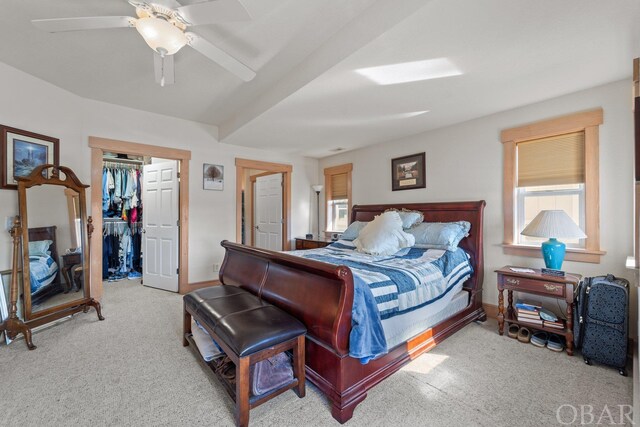 bedroom with light carpet, a closet, a ceiling fan, and baseboards