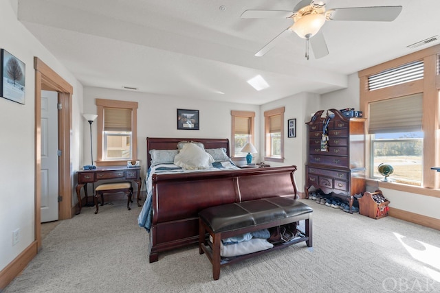 bedroom with visible vents, light carpet, and multiple windows