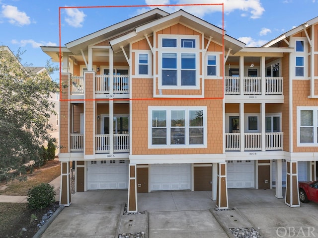 view of front facade with board and batten siding, driveway, and an attached garage