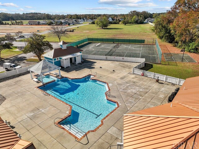 pool featuring a patio area, fence, and a gazebo