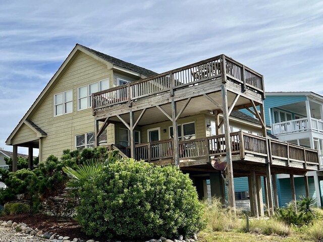 back of property featuring a wooden deck