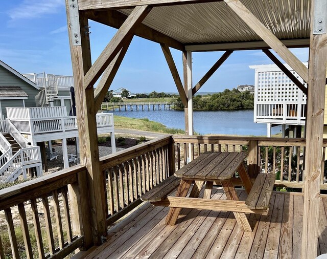 wooden terrace featuring a water view