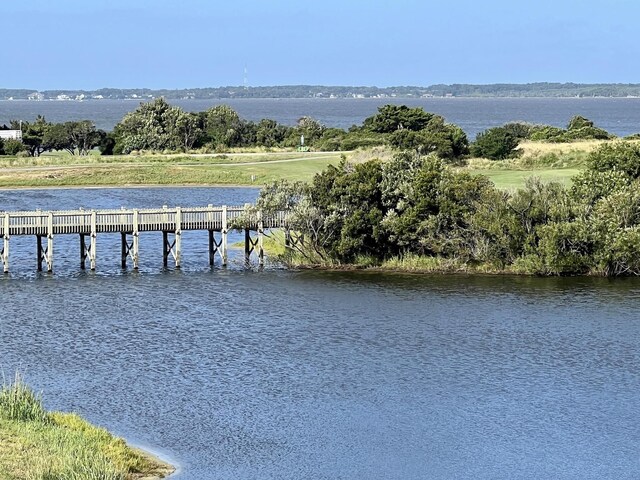 exterior space featuring a pier and a water view