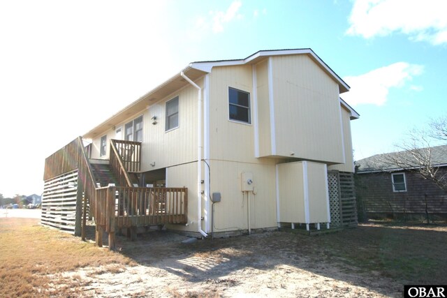 rear view of property with stairs