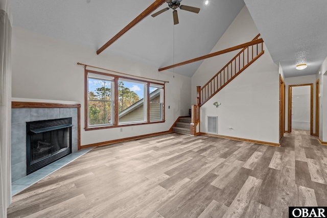 unfurnished living room featuring light wood-type flooring, stairway, baseboards, and visible vents