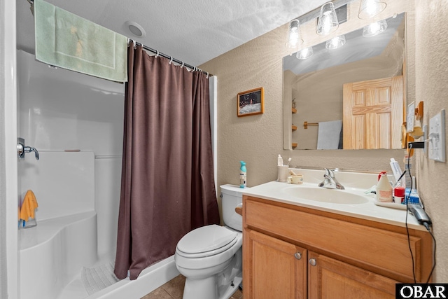 full bathroom with a textured wall, vanity, a shower stall, and toilet