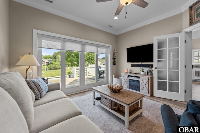 126 W Waterside Ln Lot 25, Nags Head, NC 27959 - living room featuring crown molding, light wood finished floors, a ceiling fan, recessed lighting, and a glass covered fireplace