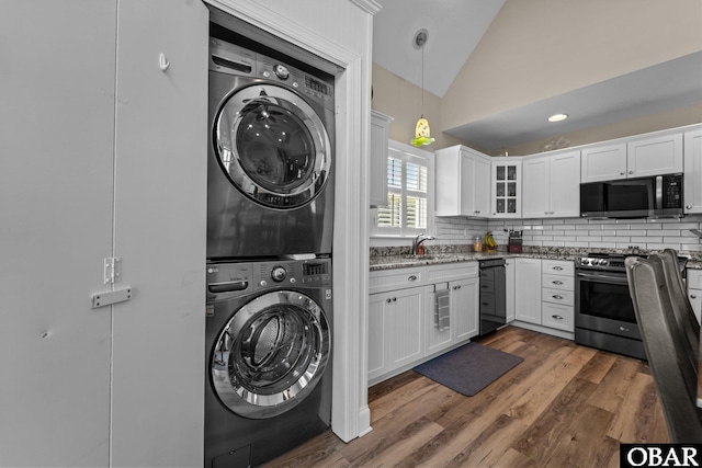 126 W Waterside Ln Lot 25, Nags Head, NC 27959 - washroom featuring estacked washer and dryer and dark wood-type flooring