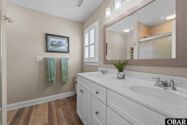 126 W Waterside Ln Lot 25, Nags Head, NC 27959 - bathroom with baseboards, a stall shower, double vanity, and wood finished floors