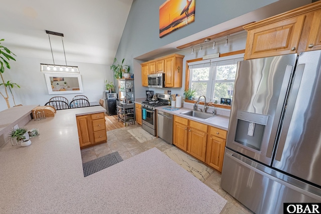 50084 Freebooter Ct Lot 177, Frisco, NC 27936 - kitchen with stainless steel appliances, light countertops, lofted ceiling, light marble finish floors, and decorative light fixtures