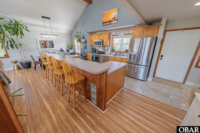 50084 Freebooter Ct Lot 177, Frisco, NC 27936 - kitchen featuring stainless steel appliances, light countertops, a breakfast bar, a kitchen island with sink, and decorative light fixtures