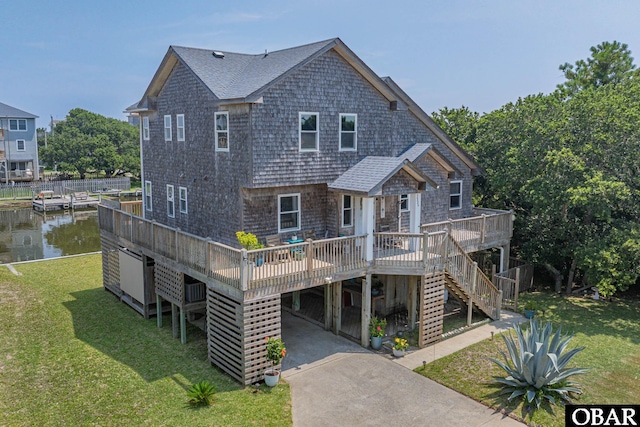 50084 Freebooter Ct Lot 177, Frisco, NC 27936 - view of front of house with a carport, roof with shingles, a deck with water view, stairway, and a front lawn