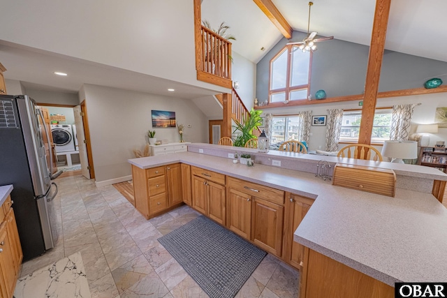 50084 Freebooter Ct Lot 177, Frisco, NC 27936 - kitchen with washer / clothes dryer, freestanding refrigerator, light marble finish floors, light countertops, and high vaulted ceiling
