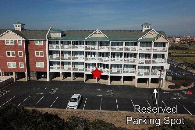 view of building exterior featuring uncovered parking