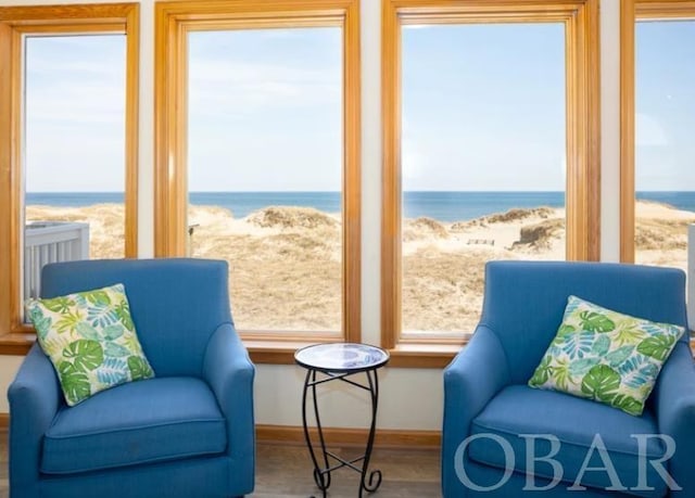 sunroom / solarium featuring a healthy amount of sunlight and a water view