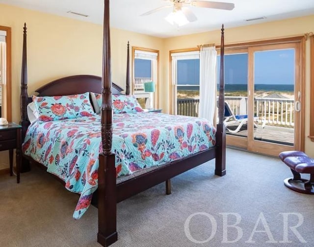 carpeted bedroom featuring access to outside, multiple windows, visible vents, and ceiling fan