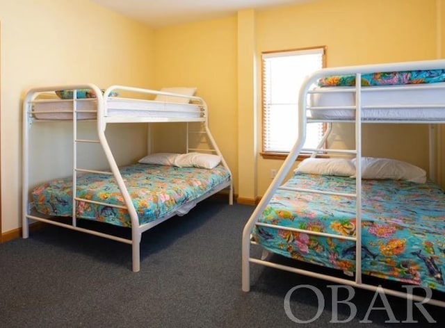 bedroom featuring carpet and baseboards