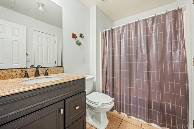 bathroom with visible vents, a shower with shower curtain, toilet, tile patterned flooring, and vanity