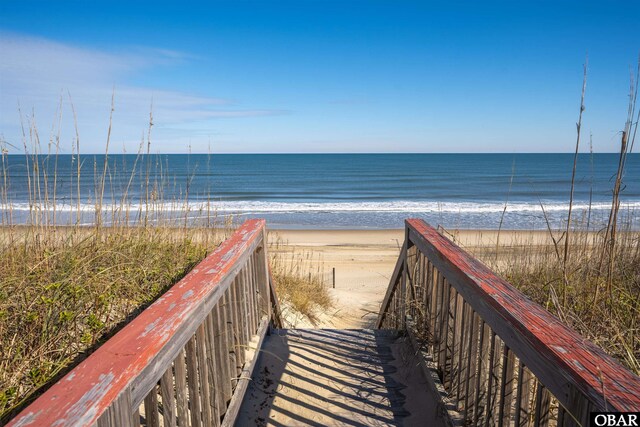 view of home's community featuring a water view and a view of the beach