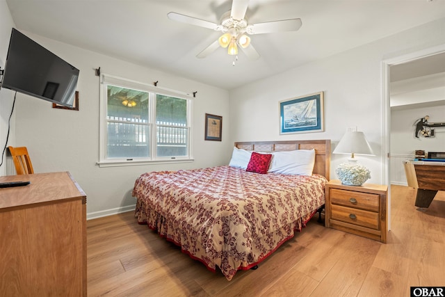 bedroom featuring a ceiling fan, light wood-type flooring, and baseboards