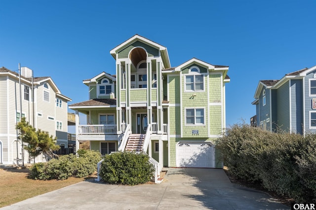 4939 S Virginia Dare Trl Lot 4, Nags Head, NC 27959 - coastal inspired home featuring driveway, a garage, and stairs