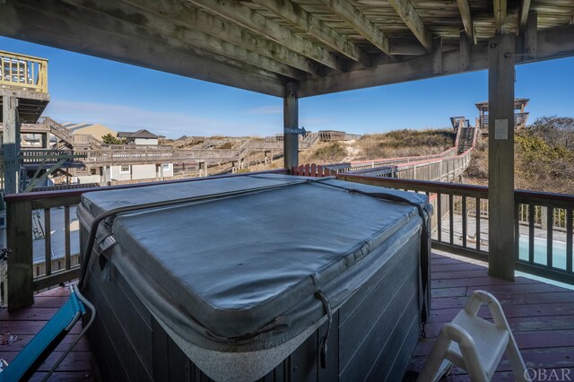 wooden terrace with a hot tub