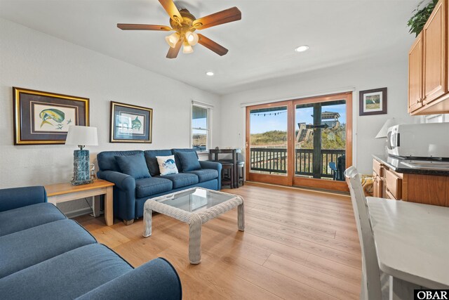 living room with ceiling fan, light wood finished floors, and recessed lighting