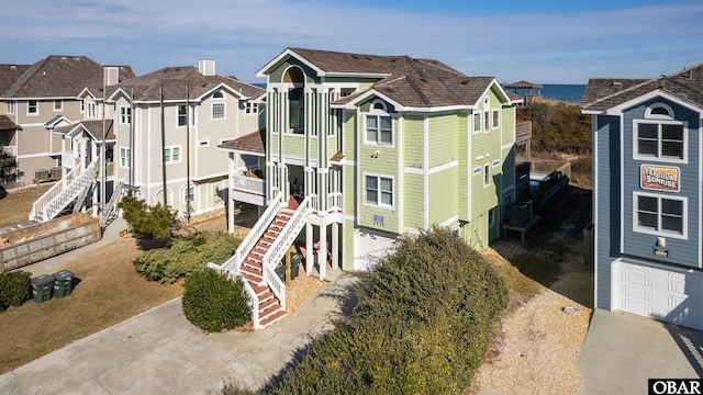 view of jungle gym featuring a residential view, cooling unit, and stairway