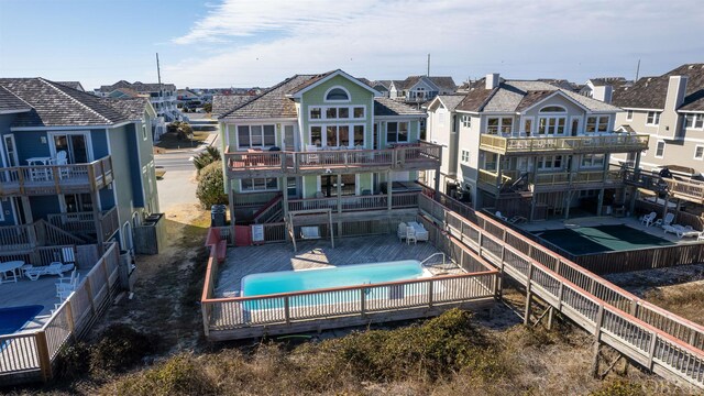 rear view of property featuring fence and a community pool